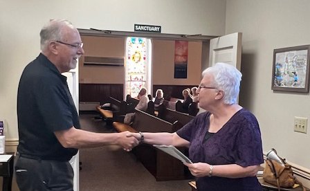 two church members shaking hands