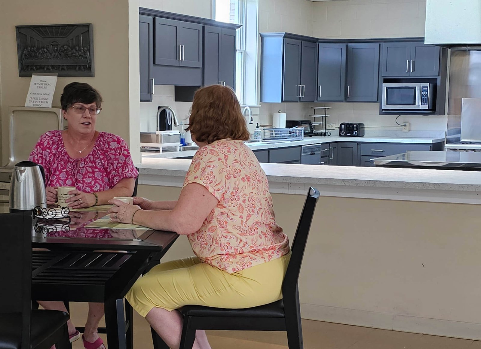 two women drinking coffee